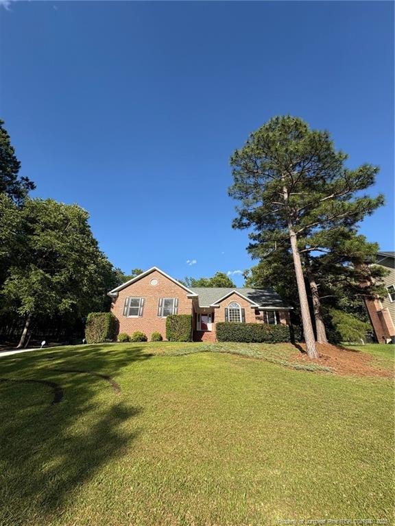 6976 Kings Lynn Loop, Fayetteville, NC 28304 - view of front facade featuring a front lawn