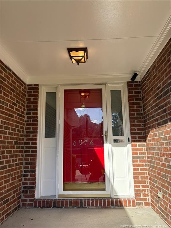 6976 Kings Lynn Loop, Fayetteville, NC 28304 - doorway to property with brick siding