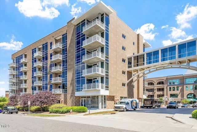 view of apartment building / complex featuring uncovered parking