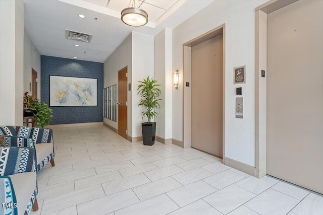 hall with elevator and recessed lighting