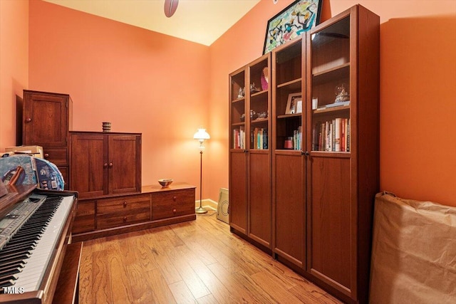 bedroom featuring light wood finished floors, ceiling fan, and baseboards