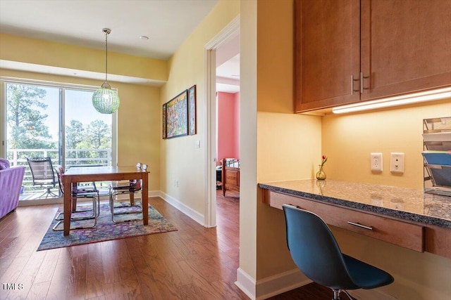 dining room featuring dark wood-style floors and baseboards