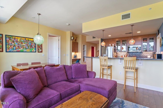 living room featuring dark wood-style flooring and recessed lighting