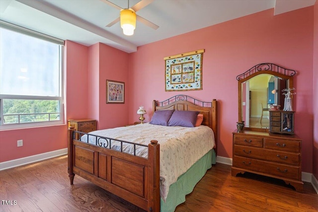 bedroom featuring baseboards, wood finished floors, and a ceiling fan