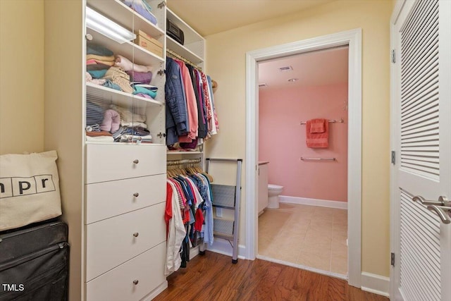 walk in closet featuring wood finished floors