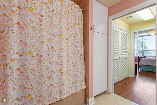 bathroom with curtained shower and baseboards