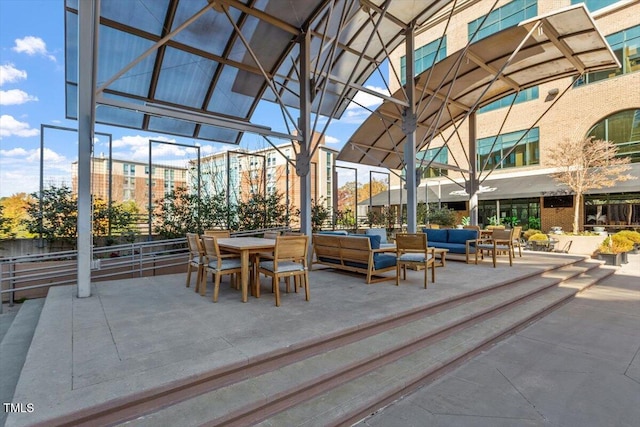 view of property's community with an outdoor living space and a patio