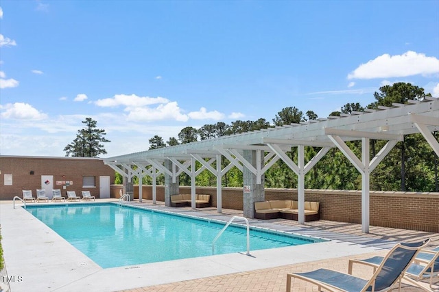 community pool with outdoor lounge area, a pergola, and a patio