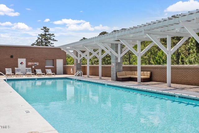 community pool with an outdoor hangout area and a pergola