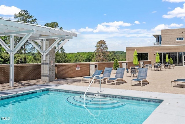 view of swimming pool featuring a pergola and a patio