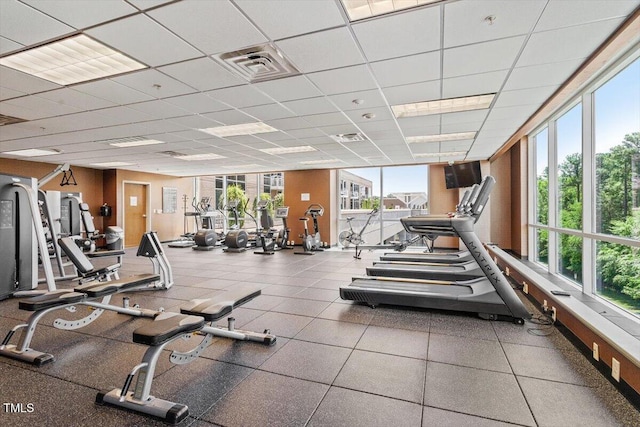 gym with a paneled ceiling