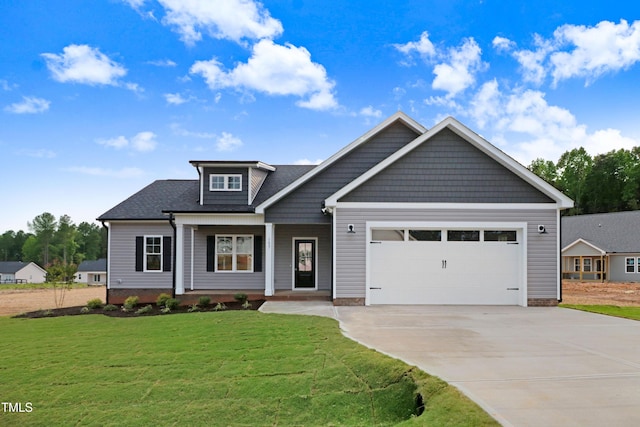 157 Gumtop Dr, Zebulon, NC 27597 - craftsman house featuring a front yard, driveway, a garage, and covered porch