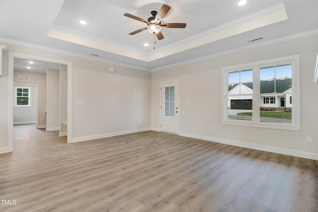 157 Gumtop Dr, Zebulon, NC 27597 - empty room featuring a raised ceiling, light wood-style floors, ceiling fan, baseboards, and recessed lighting