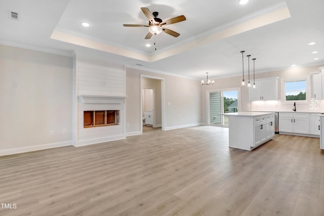 157 Gumtop Dr, Zebulon, NC 27597 - unfurnished living room featuring light wood-style floors, ceiling fan, a large fireplace, a chandelier, and recessed lighting