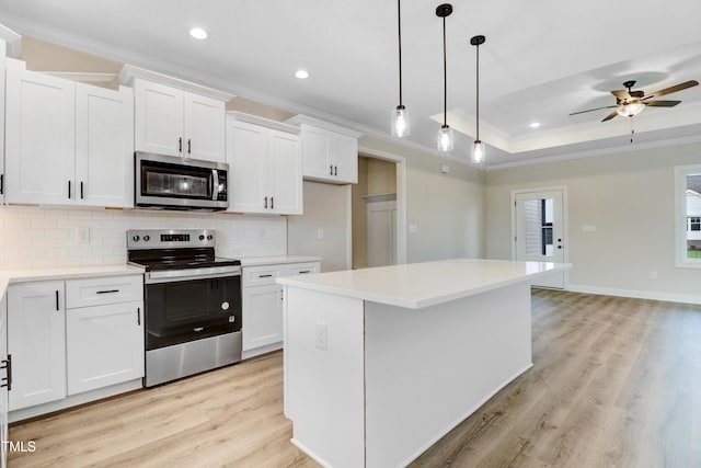 157 Gumtop Dr, Zebulon, NC 27597 - kitchen with appliances with stainless steel finishes, ornamental molding, tasteful backsplash, light wood-type flooring, and white cabinetry
