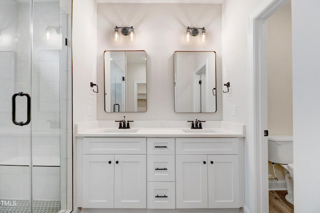 157 Gumtop Dr, Zebulon, NC 27597 - bathroom featuring a stall shower, double vanity, and toilet