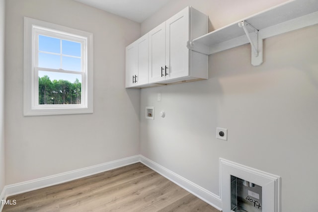 157 Gumtop Dr, Zebulon, NC 27597 - laundry area featuring hookup for a washing machine, baseboards, hookup for an electric dryer, cabinet space, and light wood-style floors