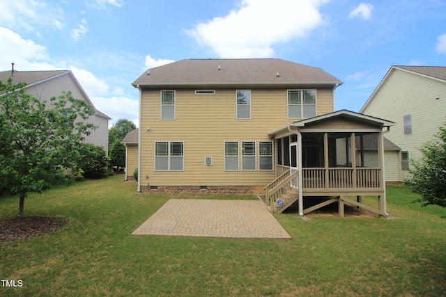 back of property with crawl space, a patio, a sunroom, and a lawn
