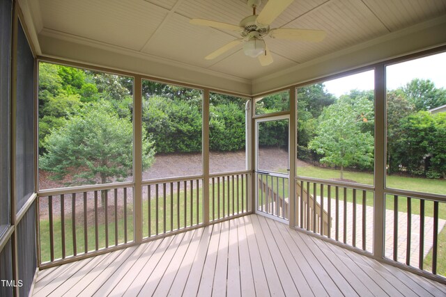 unfurnished sunroom featuring a ceiling fan