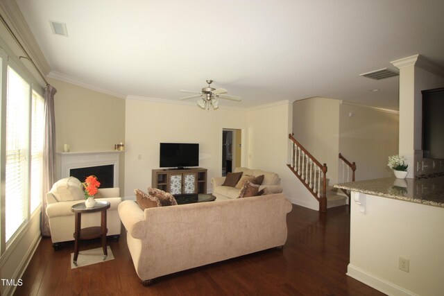 living room featuring a fireplace, dark wood-style floors, stairway, ceiling fan, and baseboards