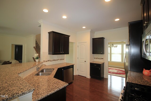 kitchen featuring a sink, appliances with stainless steel finishes, light stone counters, dark wood-style flooring, and recessed lighting