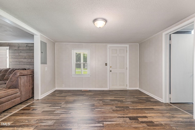 1169 Clayhole Rd, Dunn, NC 28334 - foyer with crown molding, dark wood-type flooring, a textured ceiling, wooden walls, and electric panel