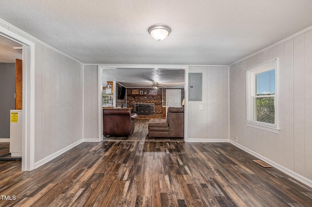 1169 Clayhole Rd, Dunn, NC 28334 - living room featuring ornamental molding, dark wood-type flooring, a brick fireplace, a textured ceiling, and electric panel