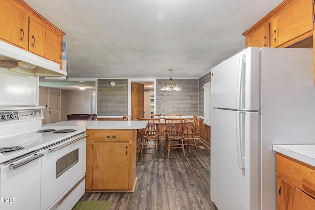 1169 Clayhole Rd, Dunn, NC 28334 - kitchen featuring white appliances, wood walls, dark wood finished floors, light countertops, and a peninsula