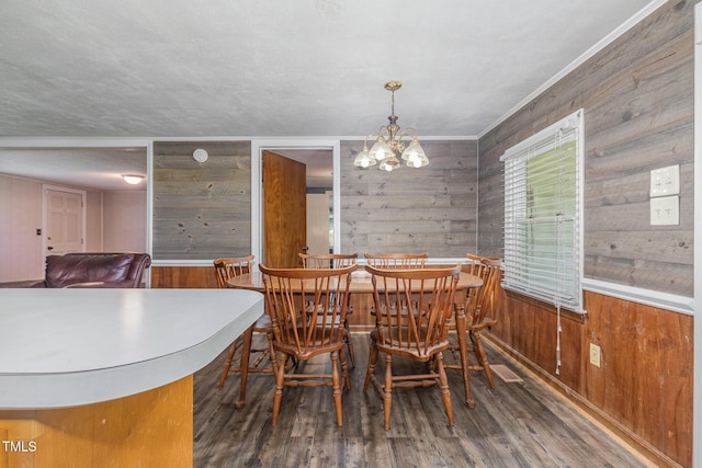 1169 Clayhole Rd, Dunn, NC 28334 - dining area with wooden walls, wood finished floors, and a chandelier