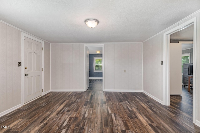 1169 Clayhole Rd, Dunn, NC 28334 - empty room featuring crown molding, dark wood finished floors, plenty of natural light, and a textured ceiling