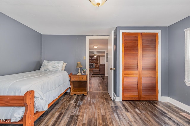 1169 Clayhole Rd, Dunn, NC 28334 - bedroom with a closet and dark wood-type flooring