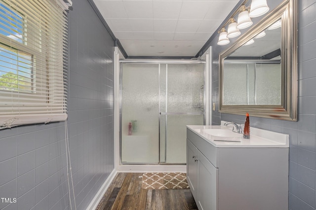 1169 Clayhole Rd, Dunn, NC 28334 - bathroom with vanity, wood finished floors, a shower stall, and tile walls
