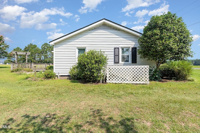 1169 Clayhole Rd, Dunn, NC 28334 - view of side of home with a yard and a deck
