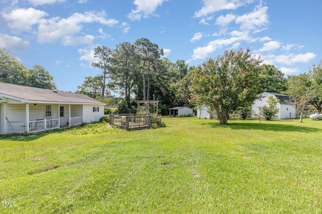1169 Clayhole Rd, Dunn, NC 28334 - view of grassy yard featuring a porch