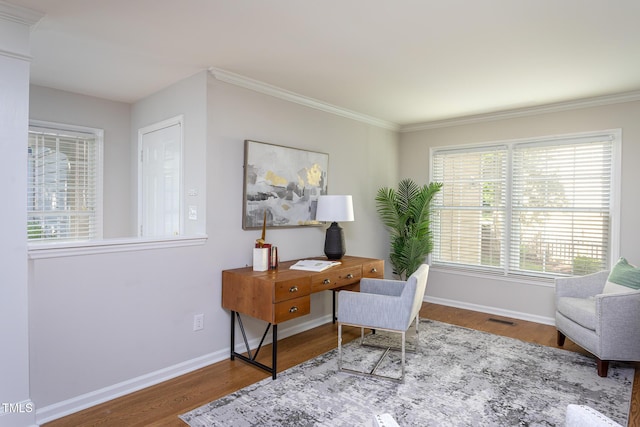 office area with wood finished floors, baseboards, and ornamental molding