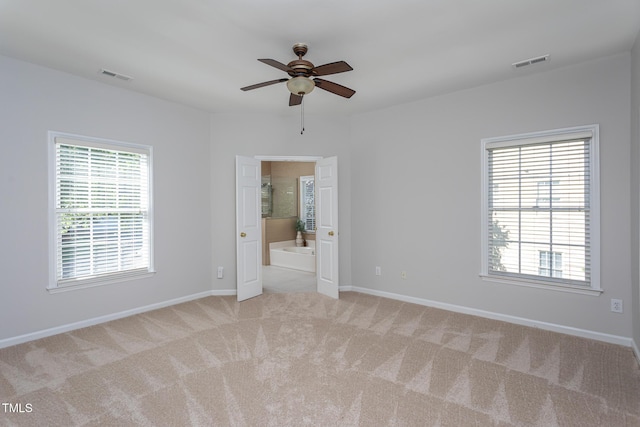 unfurnished room with carpet, ceiling fan, and baseboards