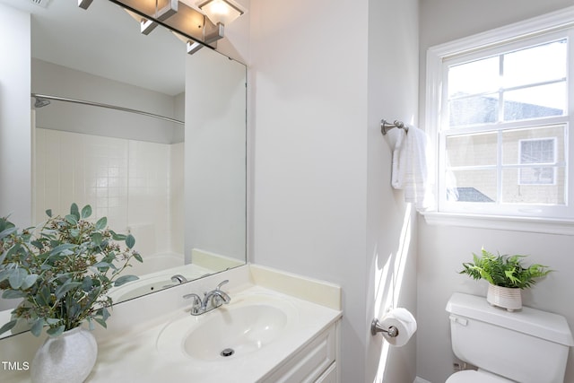 full bath featuring toilet, vanity, and a shower