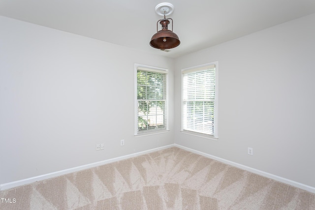 unfurnished room featuring baseboards and carpet flooring