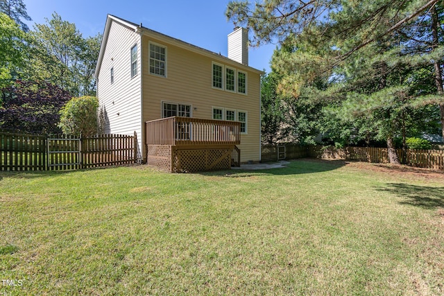 rear view of house with a chimney and a deck