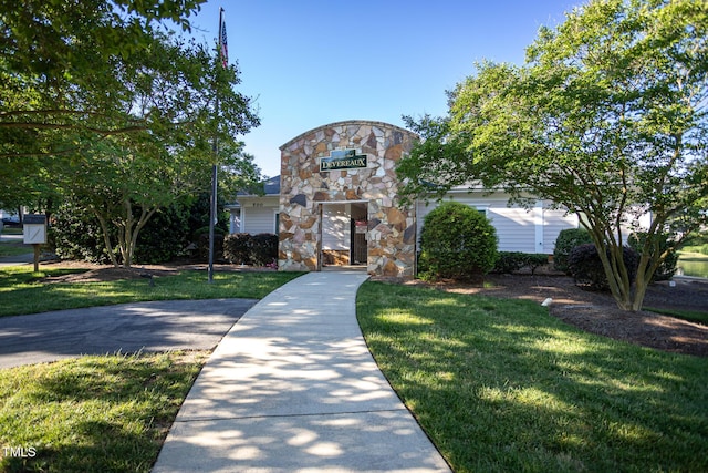 view of front facade featuring a front yard and stone siding