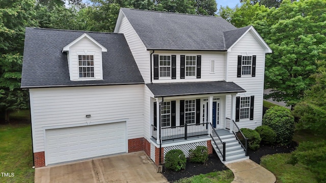 100 Citrus Pl, Cary, NC 27519 - traditional-style home featuring a porch, an attached garage, driveway, and roof with shingles