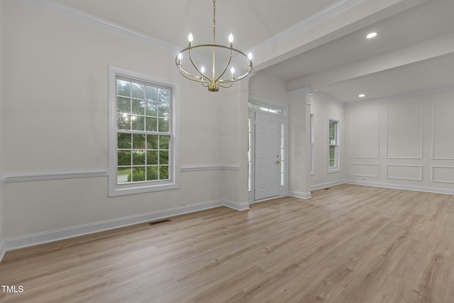 100 Citrus Pl, Cary, NC 27519 - empty room featuring ornamental molding, a chandelier, plenty of natural light, light wood-style floors, and baseboards