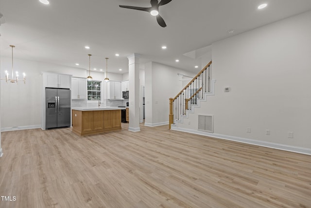 100 Citrus Pl, Cary, NC 27519 - kitchen with stainless steel refrigerator with ice dispenser, open floor plan, baseboards, a ceiling fan, and stove