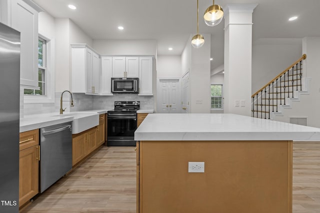 100 Citrus Pl, Cary, NC 27519 - kitchen featuring stainless steel appliances, a sink, light wood-type flooring, backsplash, and recessed lighting