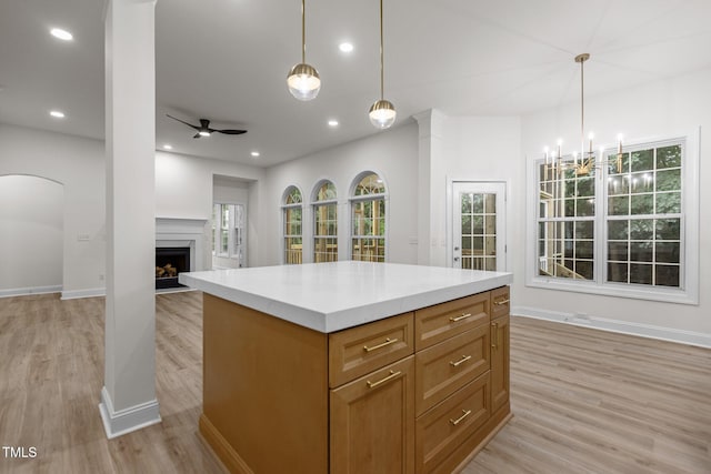 100 Citrus Pl, Cary, NC 27519 - kitchen with light wood-style floors, a fireplace, a ceiling fan, baseboards, and recessed lighting