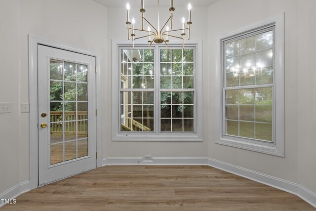 100 Citrus Pl, Cary, NC 27519 - unfurnished dining area featuring a chandelier, plenty of natural light, wood finished floors, and baseboards