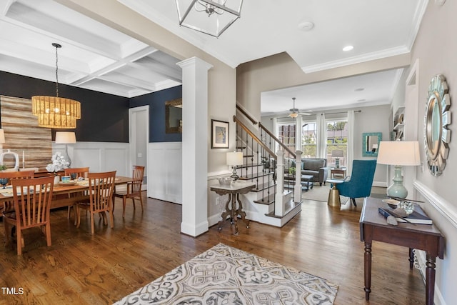 dining room with ornamental molding, coffered ceiling, ceiling fan, wainscoting, and wood finished floors