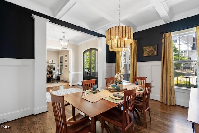 dining area with a chandelier, coffered ceiling, wood finished floors, beamed ceiling, and ornamental molding