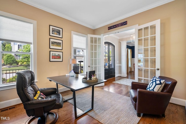 office area featuring french doors, baseboards, ornamental molding, and wood finished floors