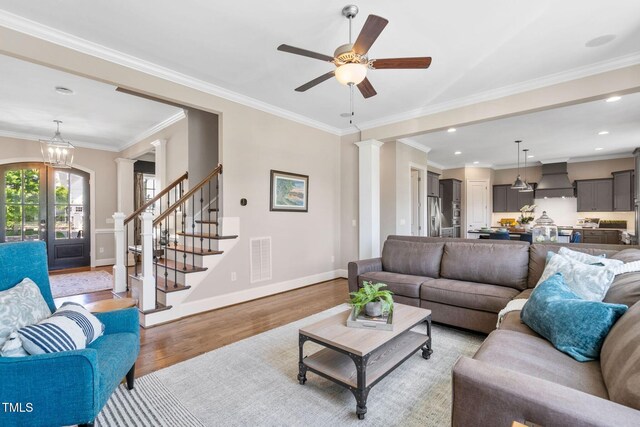 living room with light wood-style floors, ornate columns, baseboards, ceiling fan, and recessed lighting
